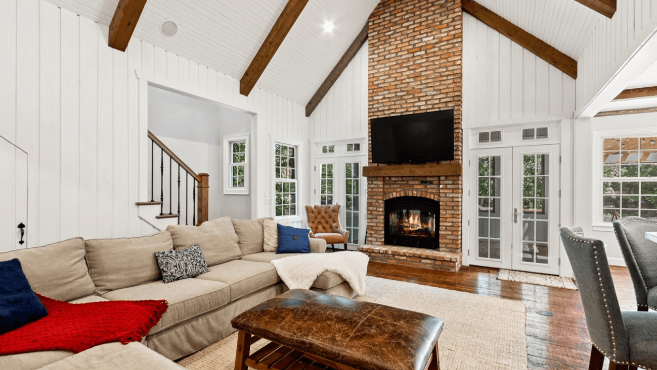 indoor/outdoor wood burning fireplace from the view of the living room in a nice large white living room