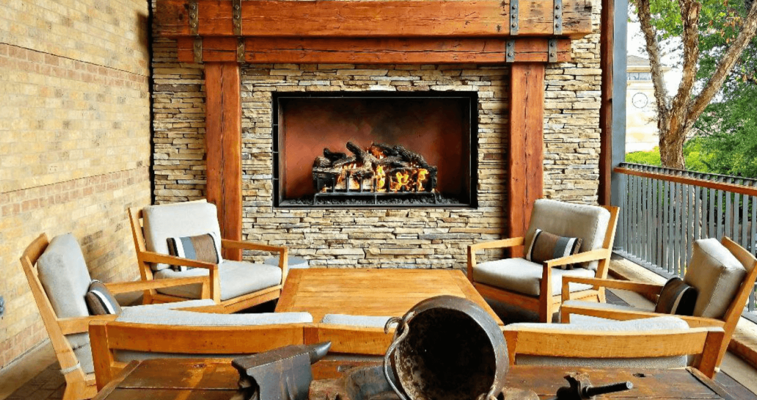 Gas fireplace outdoors with stonework surrounding the fire