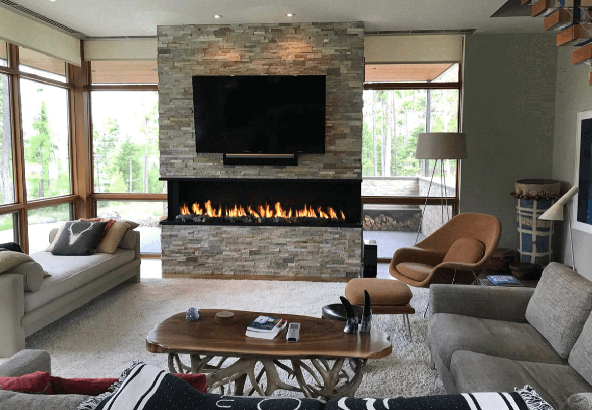 panoramic gas fireplace underneath a TV in a living room