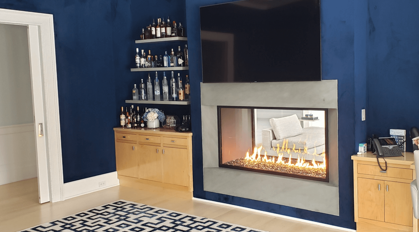 Image of a see-through gas fireplace surrounded by a bar