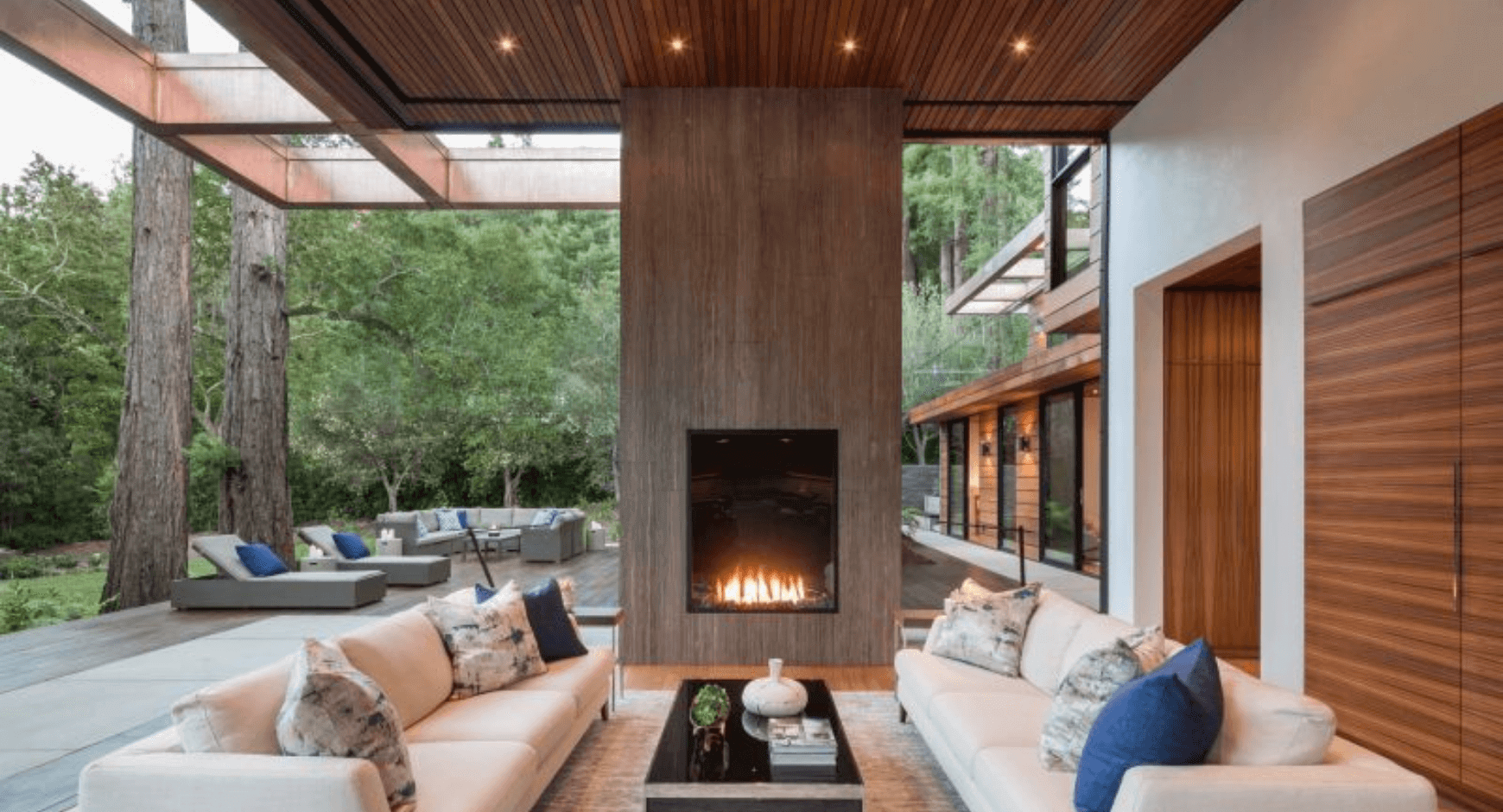 Outdoor Covered Patio with a Fireplace and Striking Contrasting Wood and Stone Features