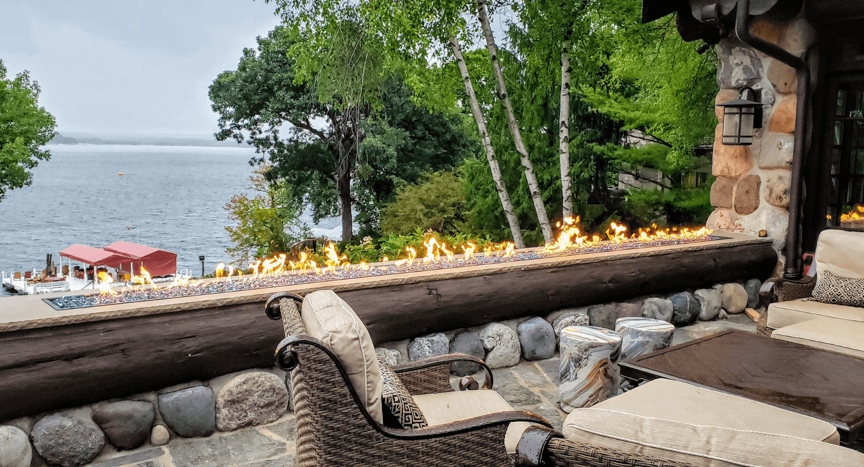 Outside Deck with a Fireplace Featuring Unique and Eye-Catching Open Flames