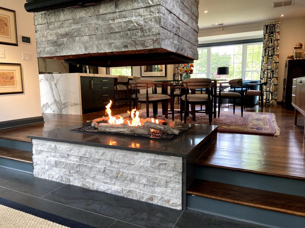 an open fireplace with a driftwood gas log set
