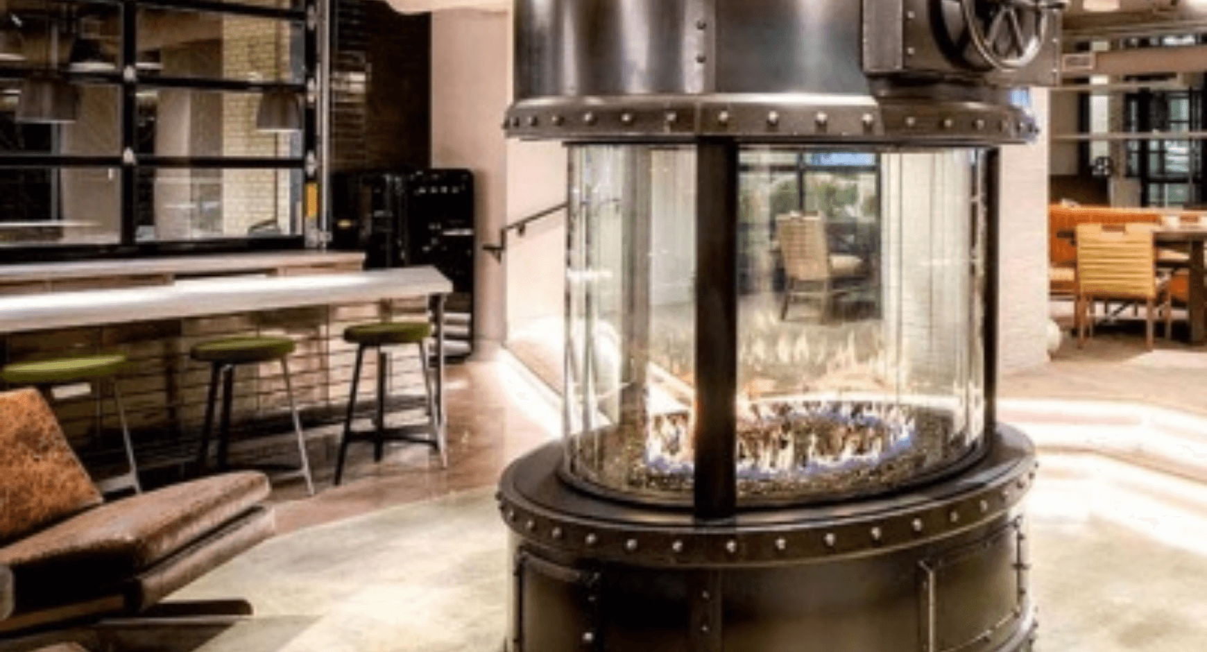 Hotel lobby design that includes a round fireplace