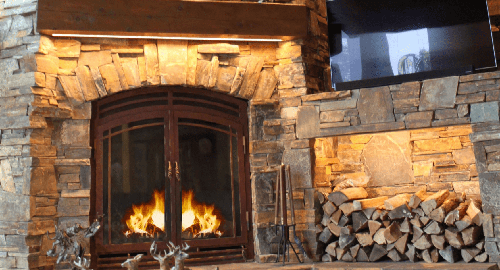 Dry stacked stone around a fireplace and wood pile