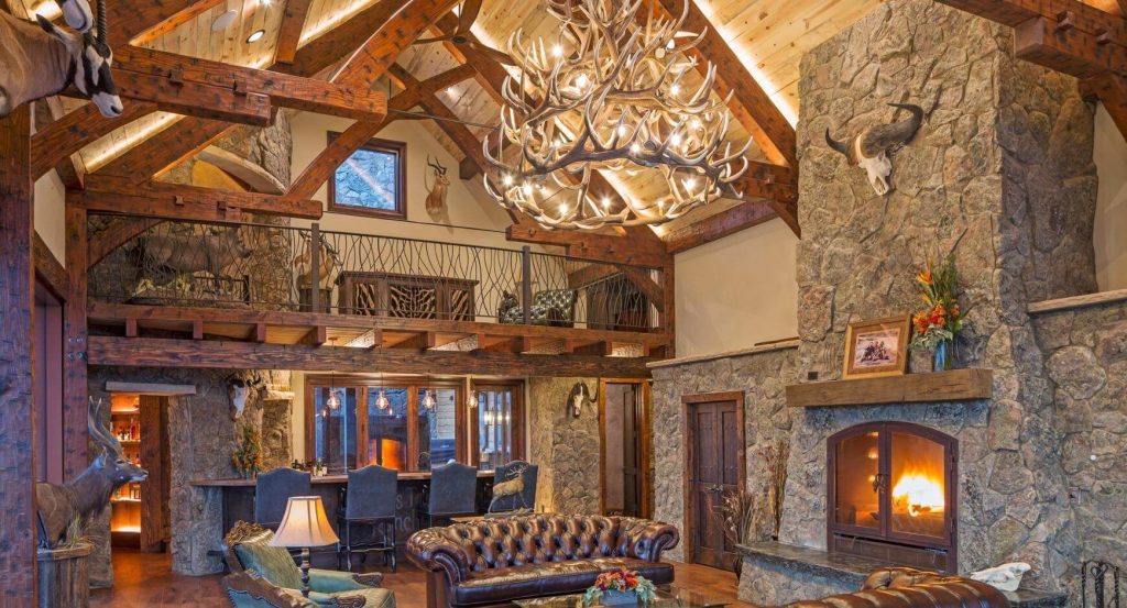 tall stone fireplace in log cabin living room