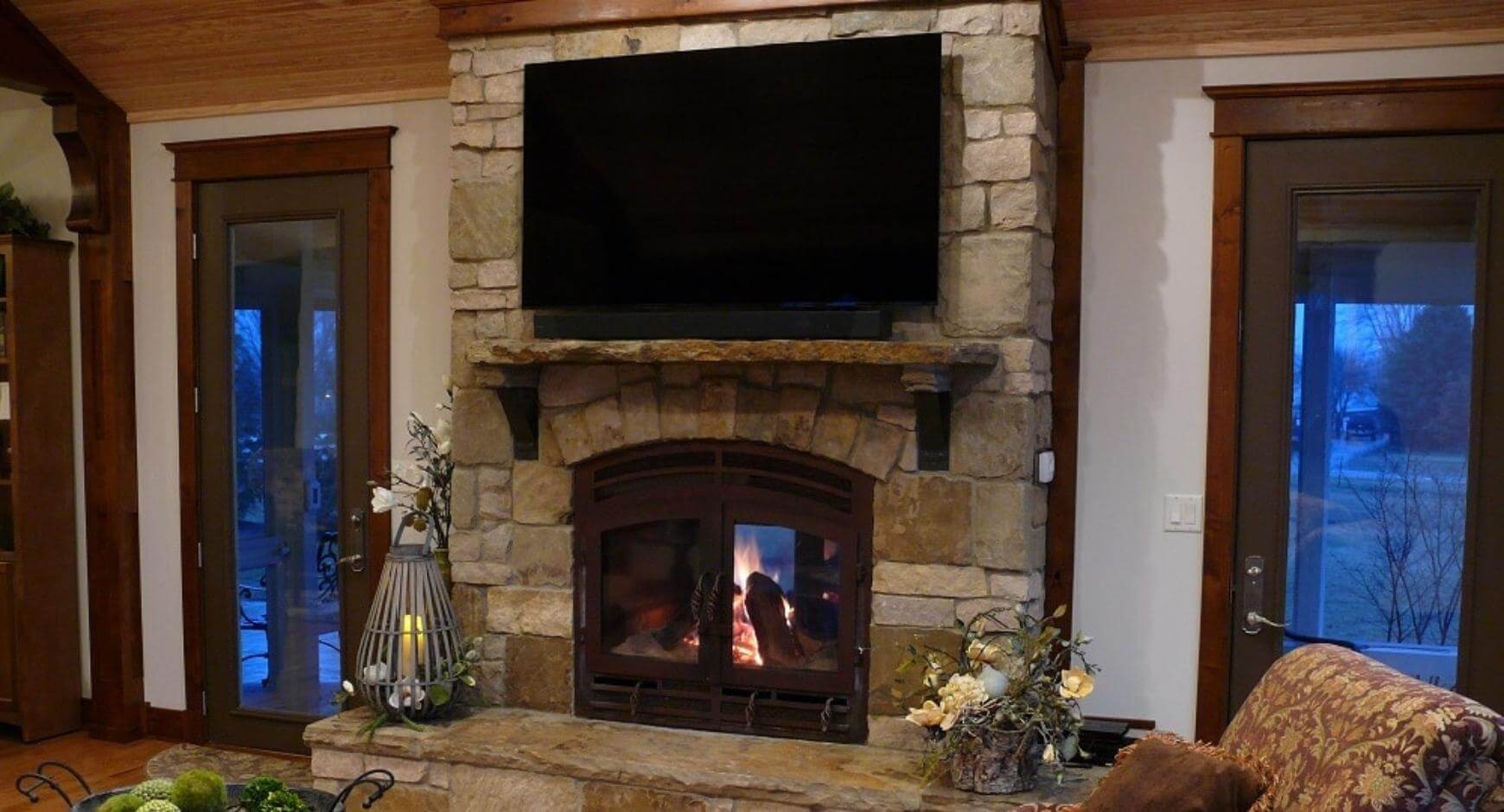 tv above a fireplace mantel