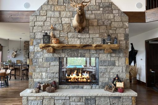 rustic double sided gas fireplace with stone