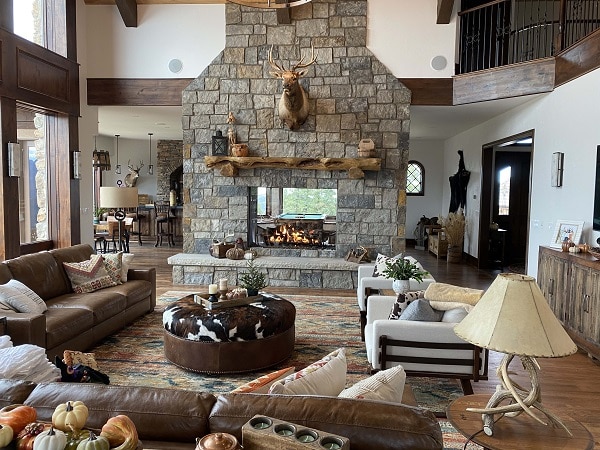 rustic living room with double sided fireplace