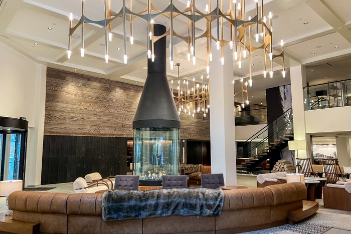 a modern hotel lobby with a custom-built round gas fireplace