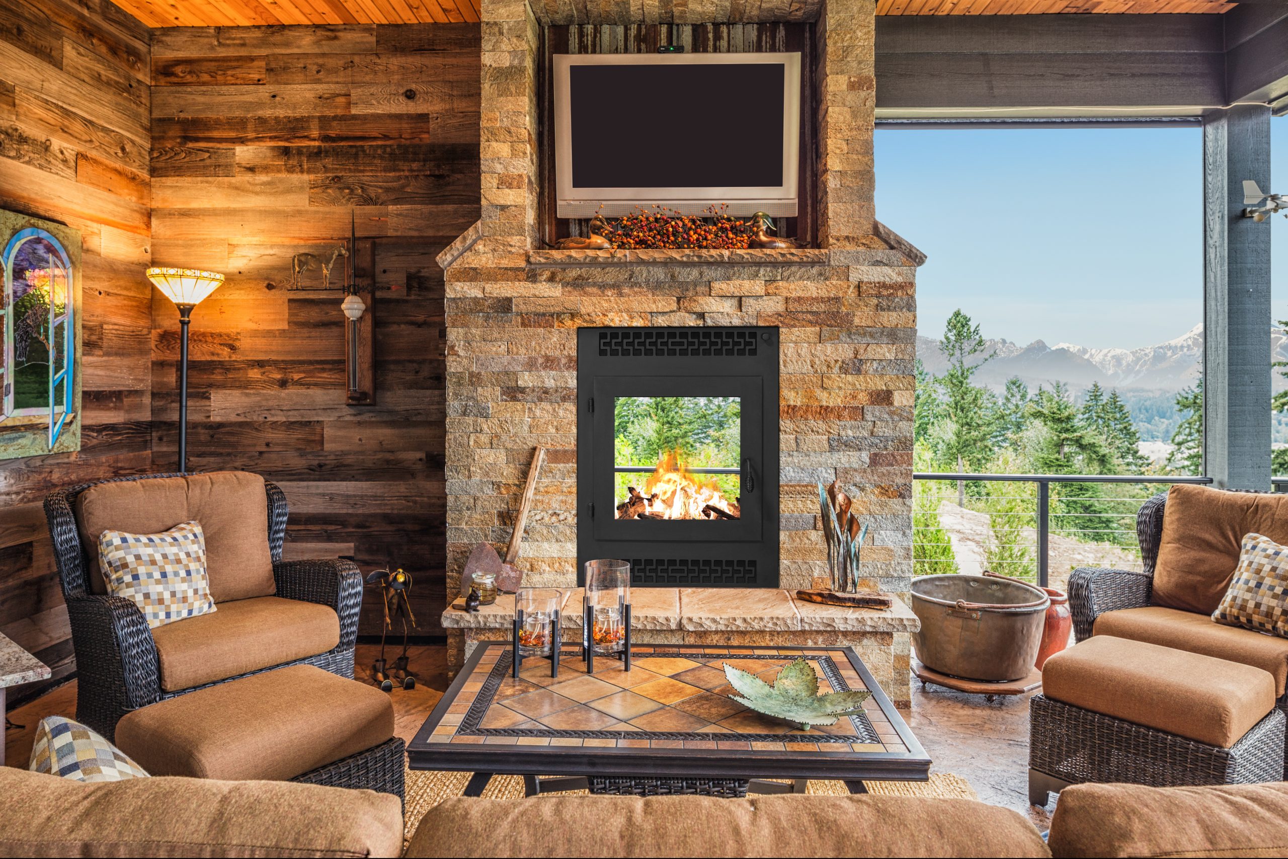 an inside-outside small fireplace in a cabin living room