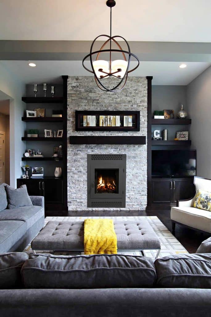 modern gray living room with light stacked stone fireplace