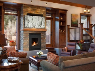 chabby chic living room with stacked stone wood burning fireplace