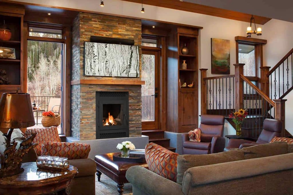 chabby chic living room with stacked stone wood burning fireplace