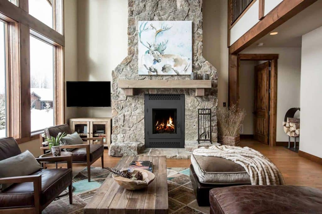 rustic living room with stone fireplace
