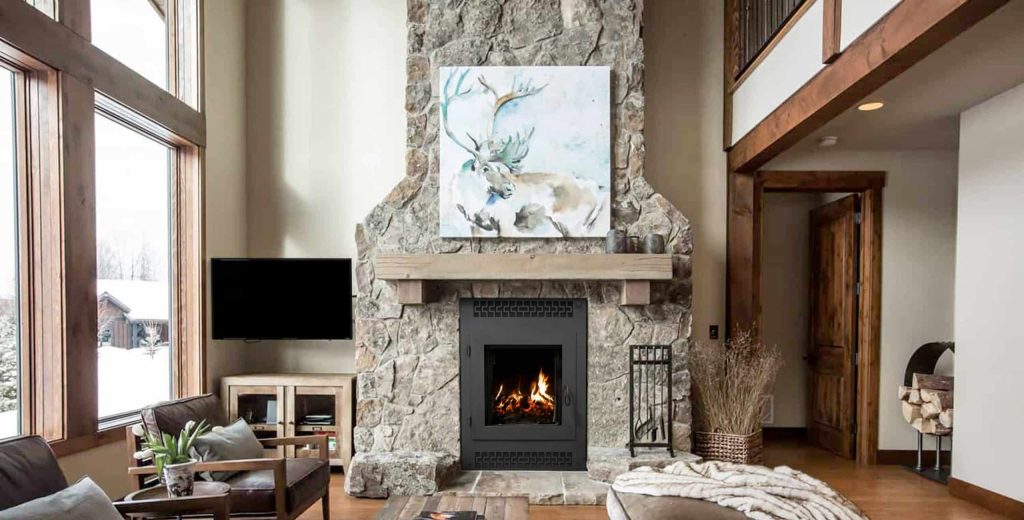 rustic living room with stone fireplace