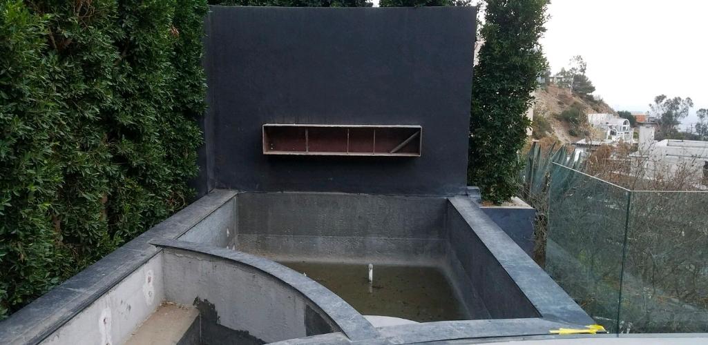 a before picture of a pool fireplace