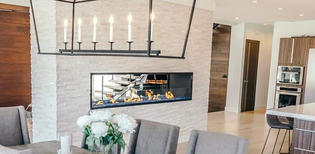 a double sided fireplace in a kitchen and hallway