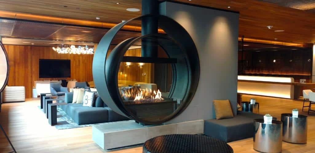 a dual-ring fireplace in a hotel lobby