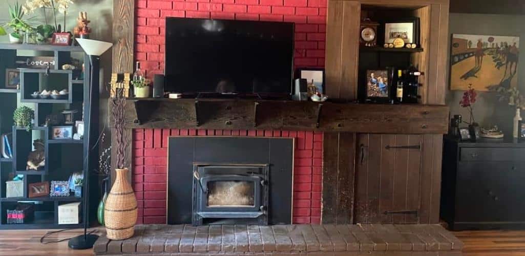 an old wood burning fireplace with a red brick surround