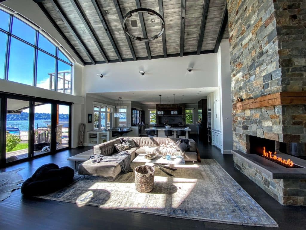 A living room with throw blankets and an open fireplace