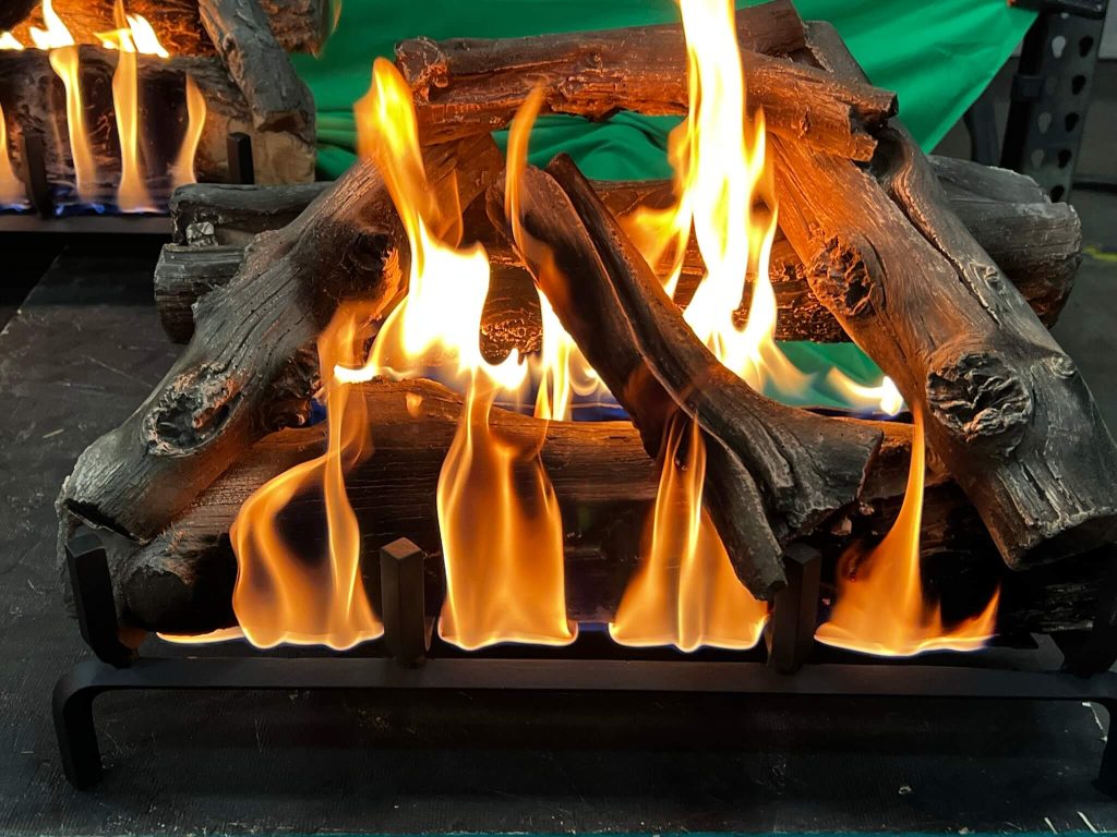 a gas fire with a driftwood log set