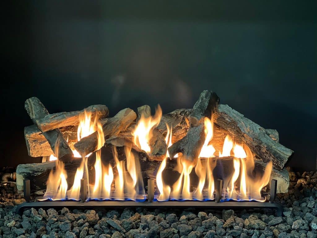 a weathered oak log set in a gas fireplace