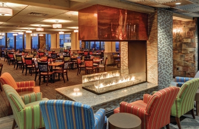 restaurant fireplace with open view and glass barrier