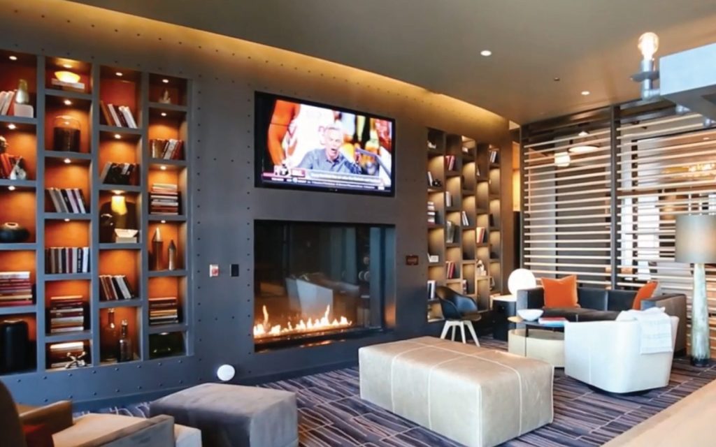 shared amenity space with a tall modern gas fireplace