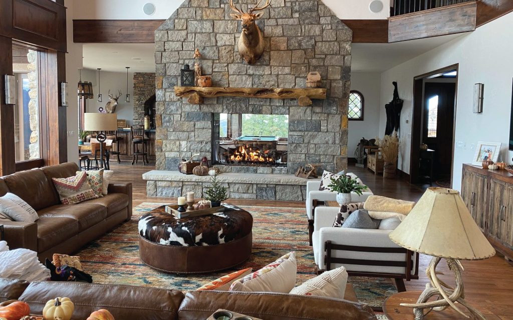 a traditional stone fireplace with gas logs in rustic cabin living room