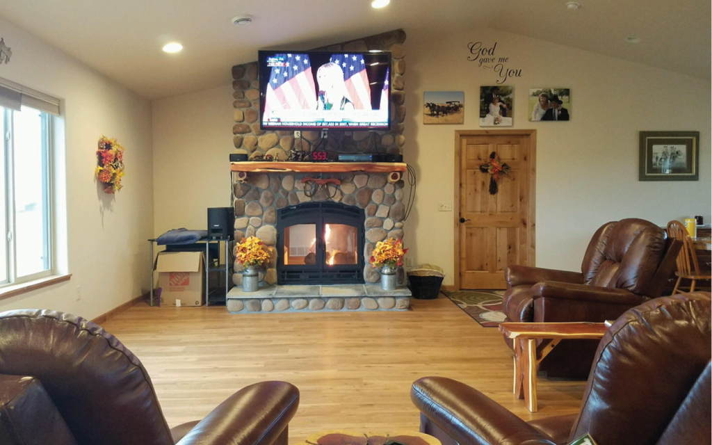 a two sided wood burning fireplace in a cabin living room