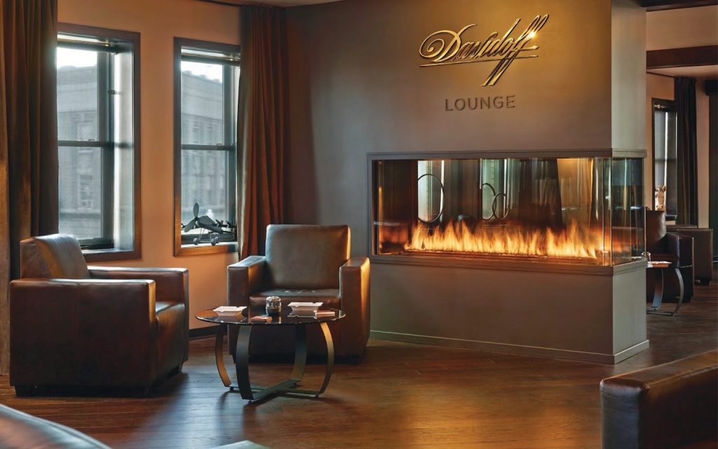 a 3 sided multi view gas fireplace in a cigar lounge