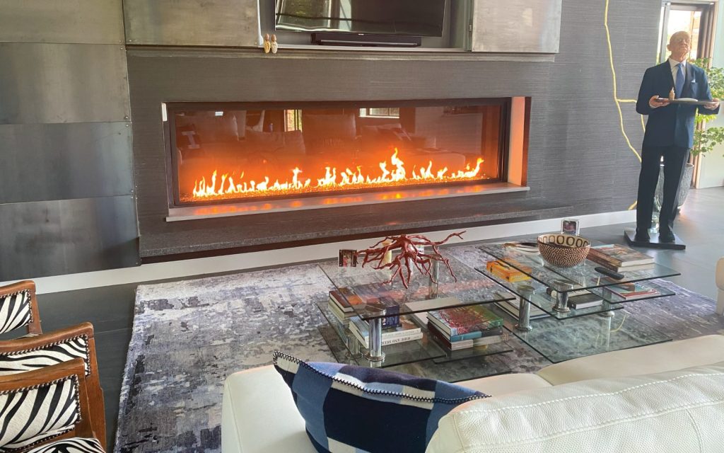 an art deco inspired living room with long linear gas fireplace