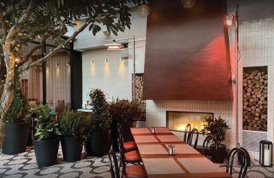 nyc eatery with double sided indoor outdoor gas fireplace with patio seating