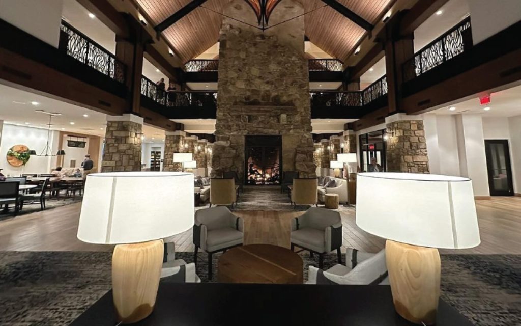 a large fireplace with custom doors in a hotel lobby