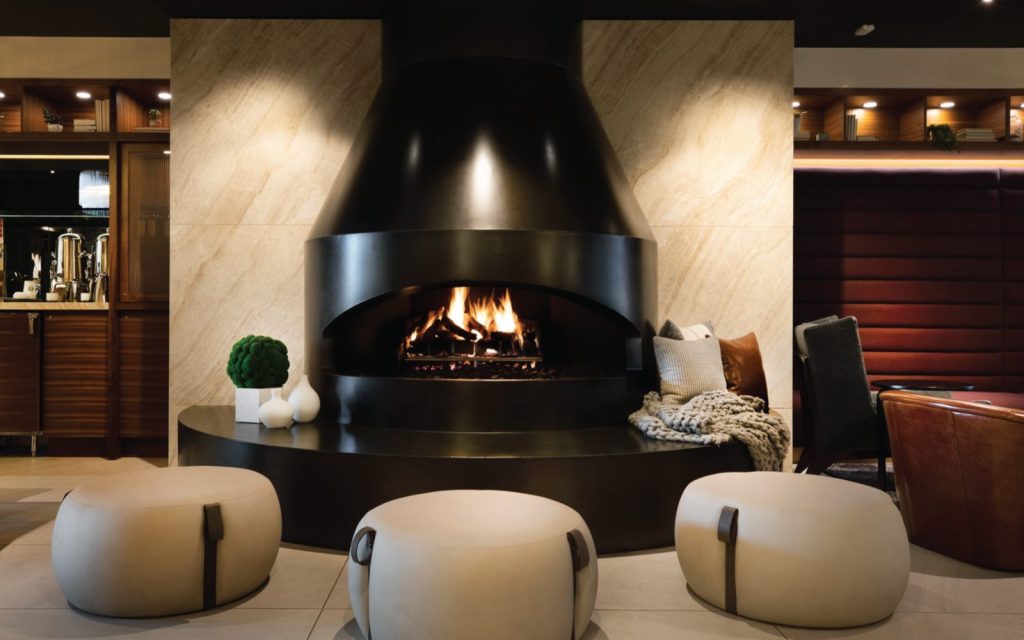 a custom unique fireplace with gas logs and an open viewing area