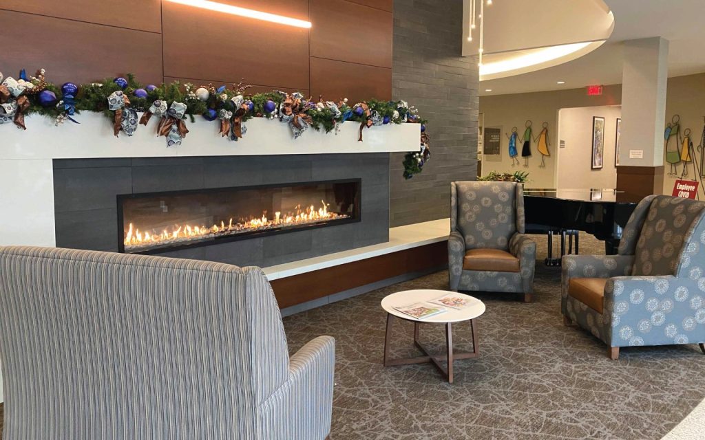 slim front facing fireplace with slate finish in healthcare facility