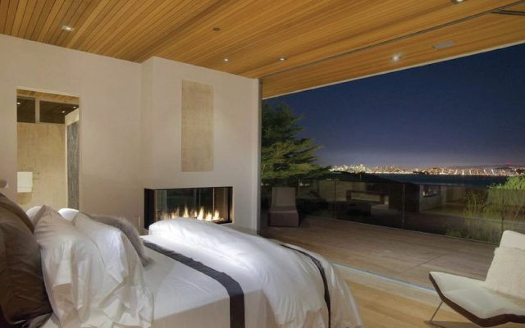 a gas fireplace with multiple views in a master bedroom overlooking san francisco bay