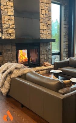 classic double sided indoor outdoor wood fireplace with double doors in cozy modern living room
