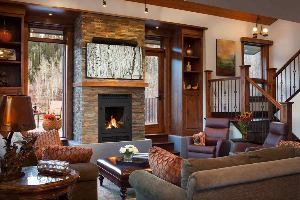 front facing wood fireplace with single door in cozy cabin living room