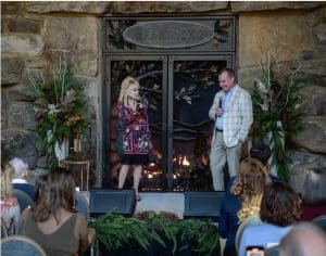 Dolly Parton standing in front of Acucraft custom fireplace at Dollywood HeartSong Resort