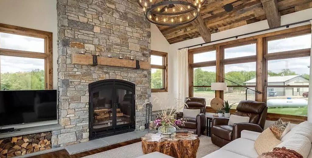 an image of a rustic living room with a large single sided wood burning fireplace