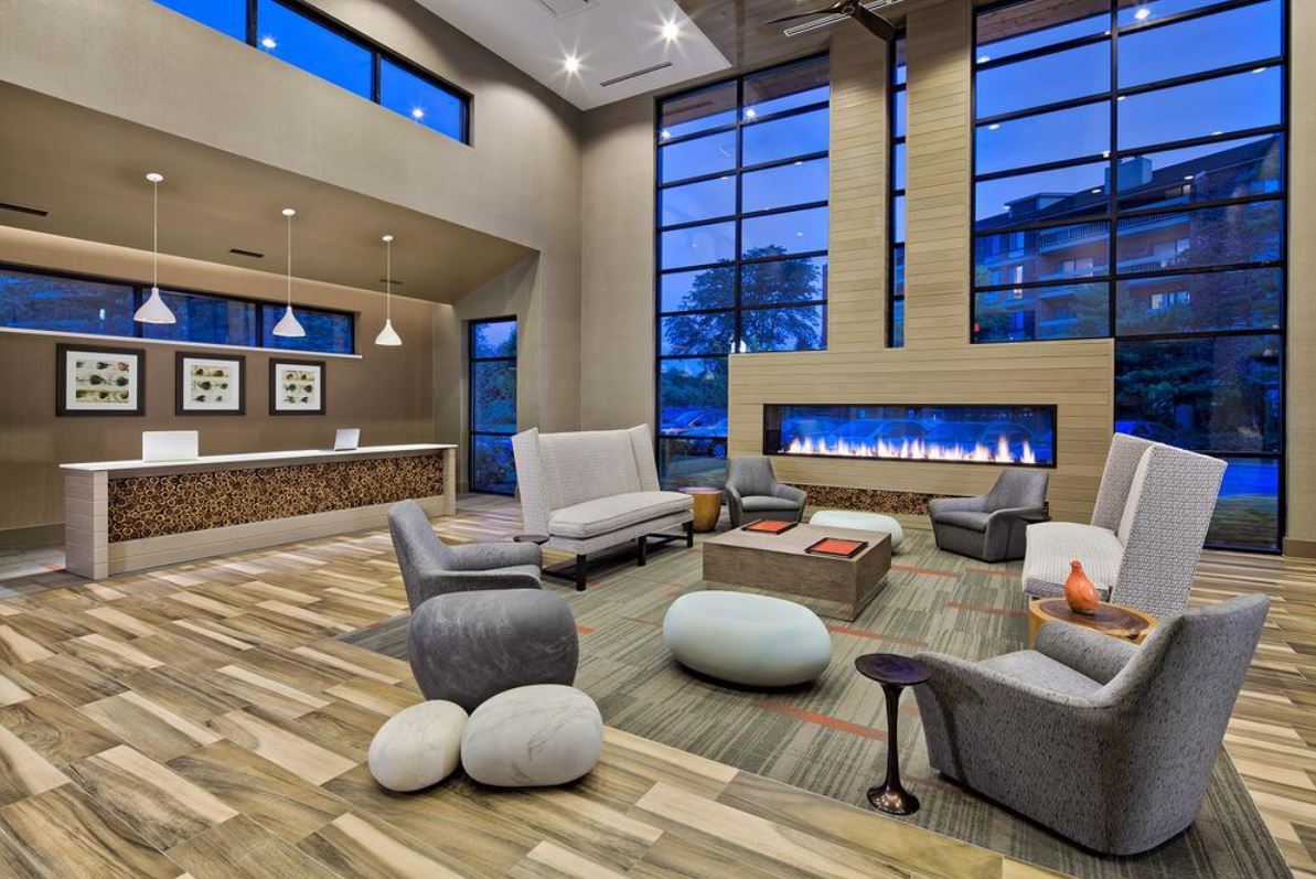 An indoor/outdoor gas fireplace connecting a living room and patio, providing a seamless view of flames from both spaces.
