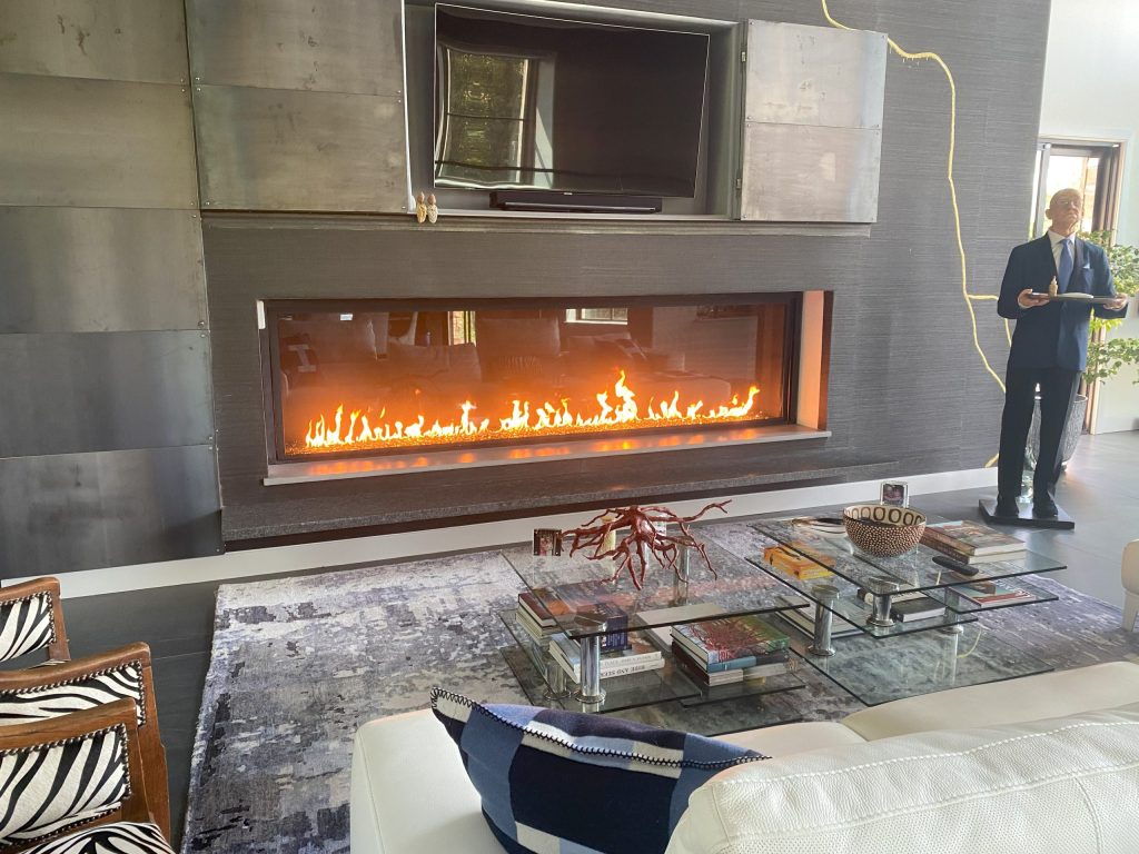 A classic single-sided gas fireplace with a traditional mantel, serving as the focal point of a cozy living room.