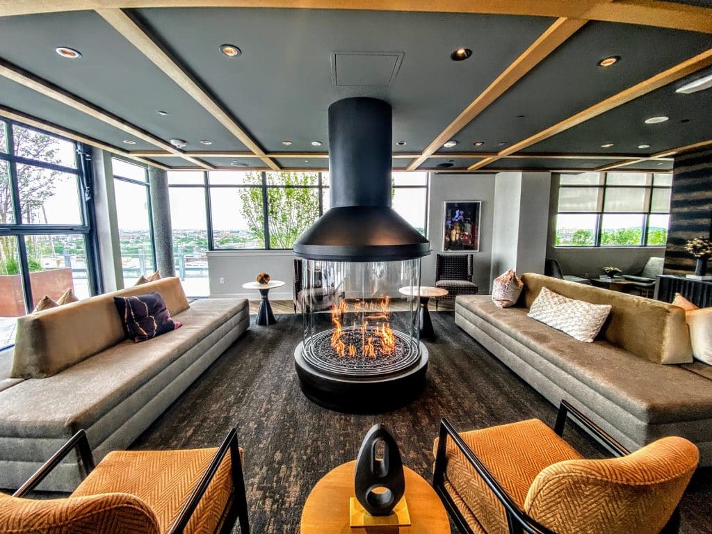 360-degree glass gas fireplace creating a warm, elegant focal point in a modern lounge