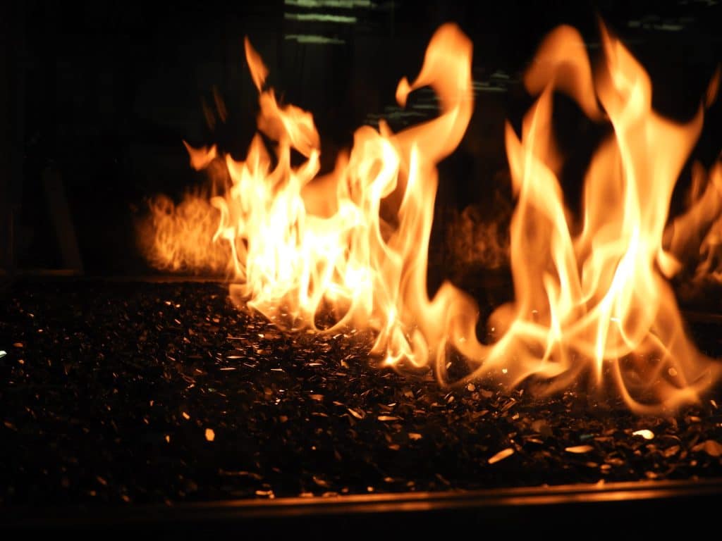 Intense flame shot showcasing the radiant ambiance of a custom-built fireplace