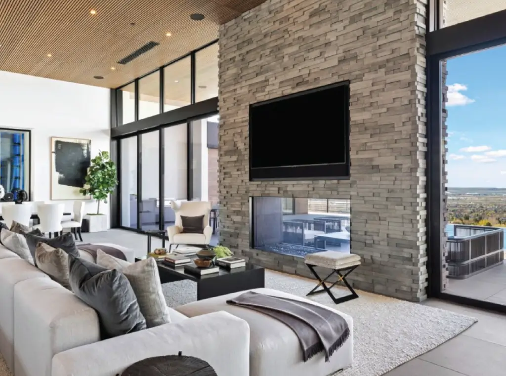 Two-sided fireplace transitional living room with indoor outdoor hearth