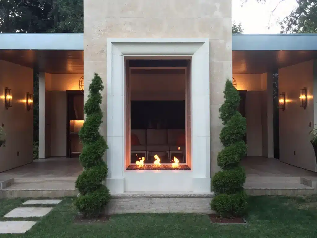 Acucraft custom gas torch burners creating flames in an outdoor architectural feature