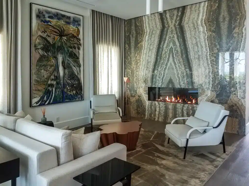 Acucraft Signature Series see-through gas fireplace in a contemporary room with a stone feature wall