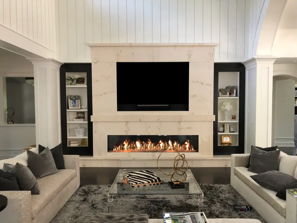 Acucraft Signature single-sided linear gas fireplace below a television in a symmetrical feature wall